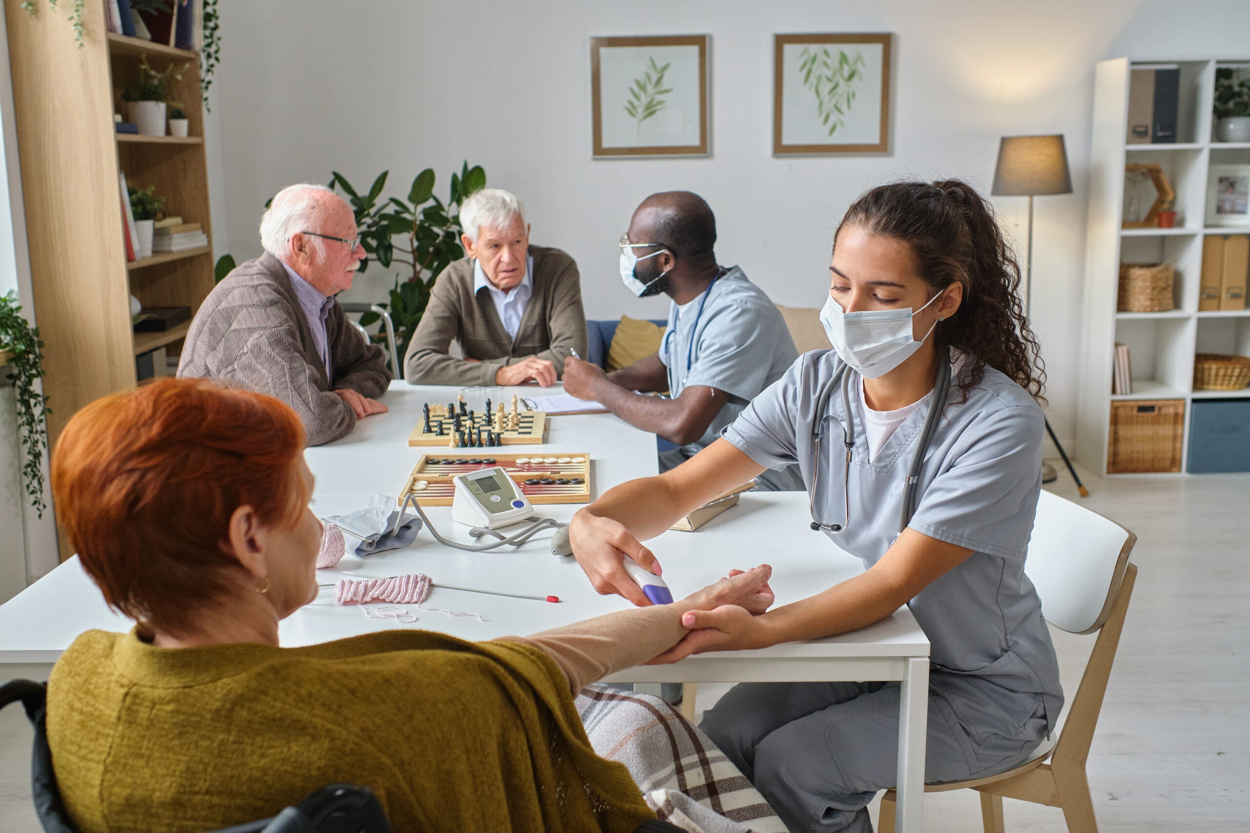 Nurse holding medical exam for senior people