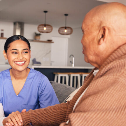 Happy woman, nursing home and man with disability in wheelchair for medical trust, wellness advice .